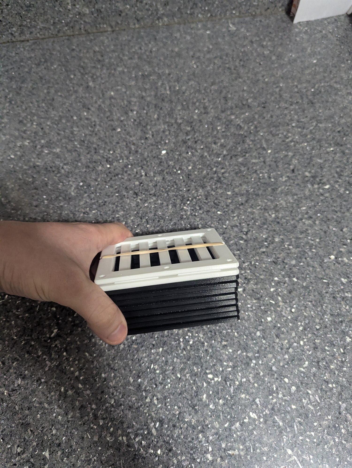 Stack of five black and white 3D-printed Card Humidity Brace 2.0 units made for a customer