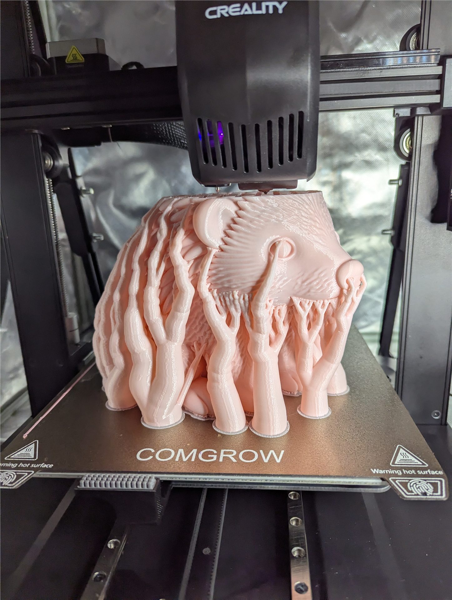 Pink custom hedgehog print in progress on a Creality printer