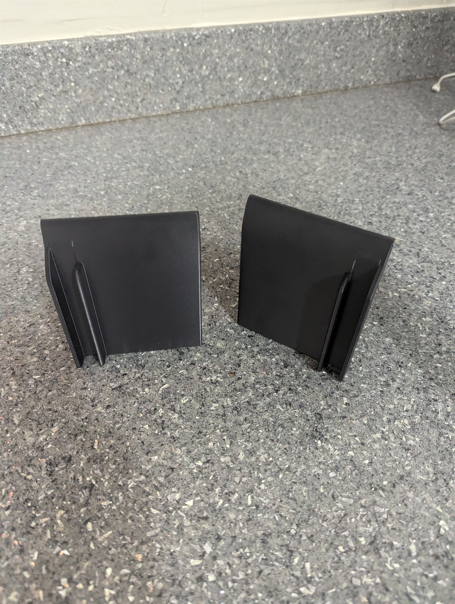 Rear view of a pair of black 3D-printed generic 5/8-inch vehicle splitter end plates