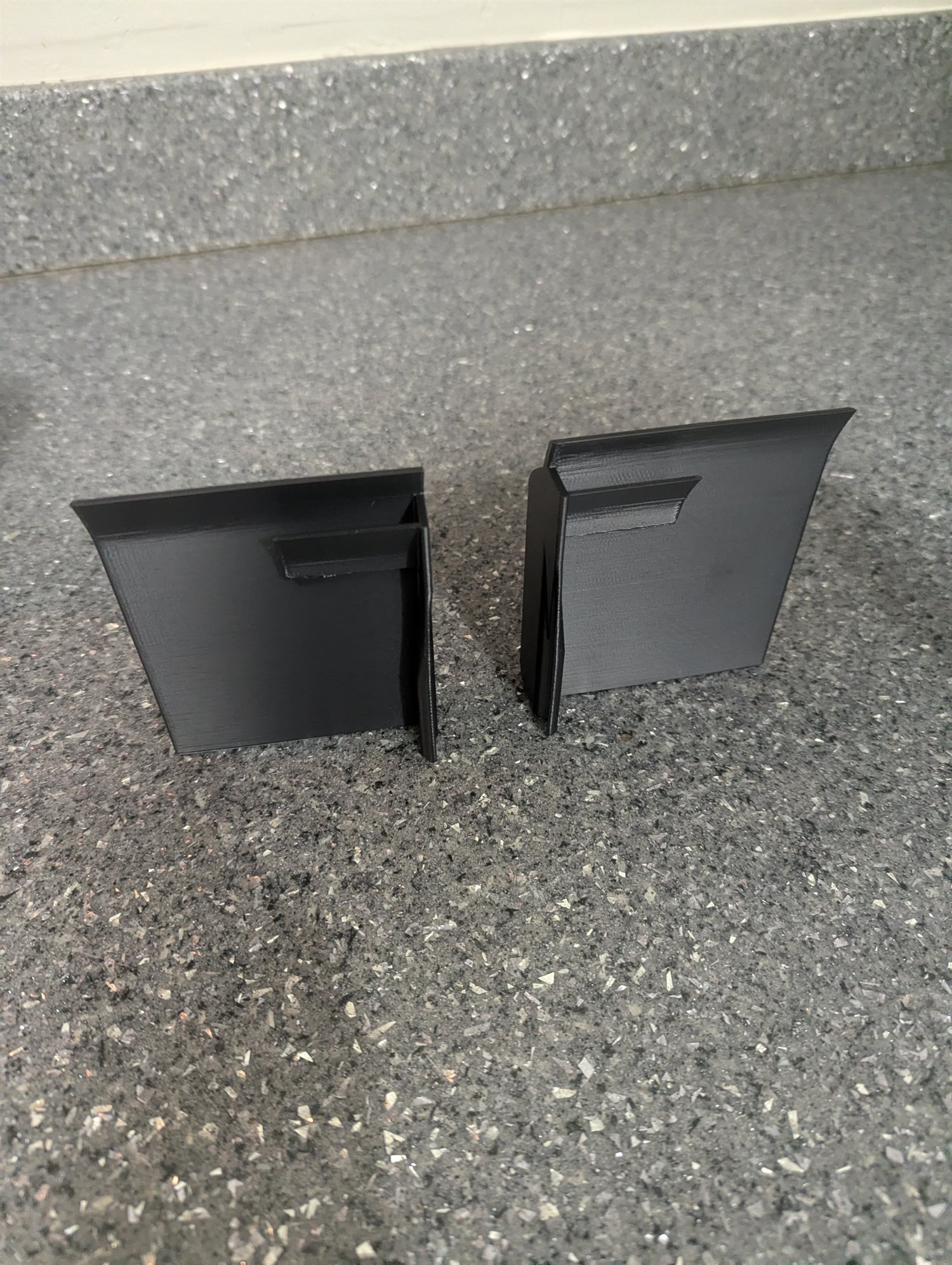 Pair of black 3D-printed generic 5/8-inch vehicle splitter end plates viewed from the front