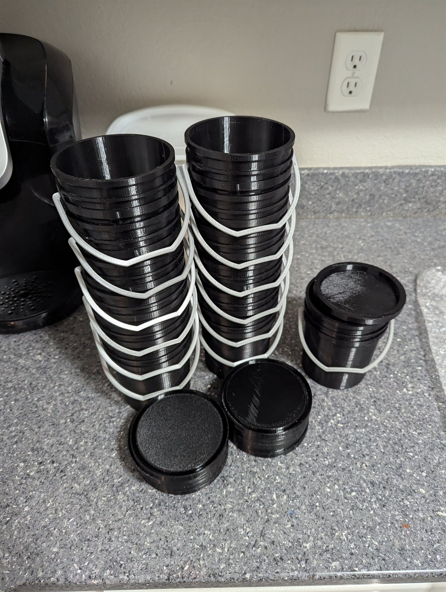 Customer order of 13 black miniature five-gallon buckets with gray handles and matching lids