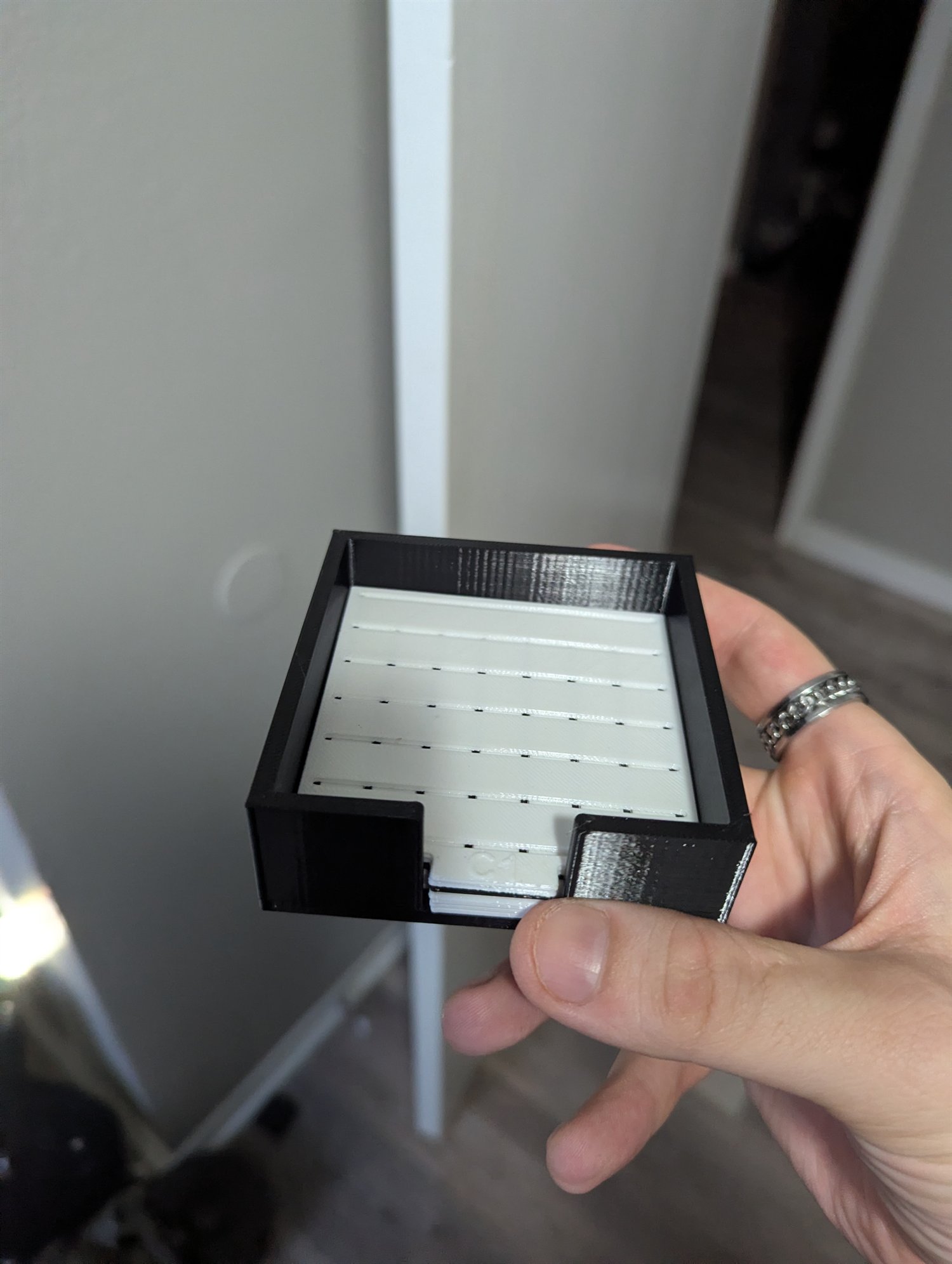 Customer-ordered 3D-printed sticky-note stencil assembled in its black holder