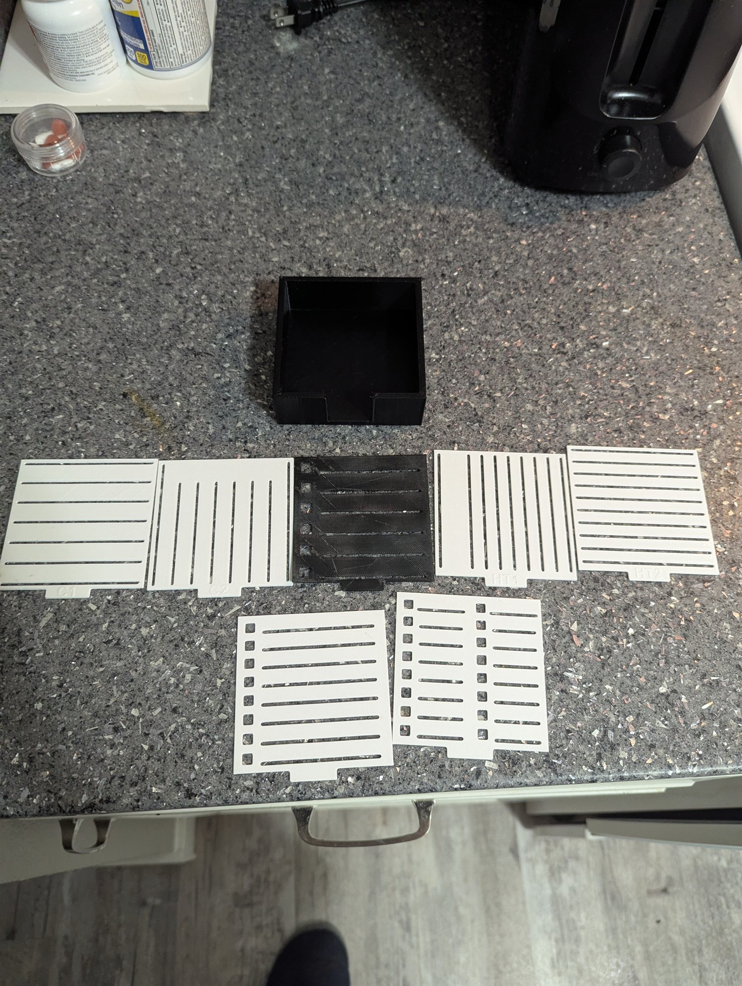 Black sticky-note holder with multiple interchangeable 3D-printed line stencil plates